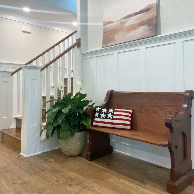 entryway with American-made hardwood and American flag pillow